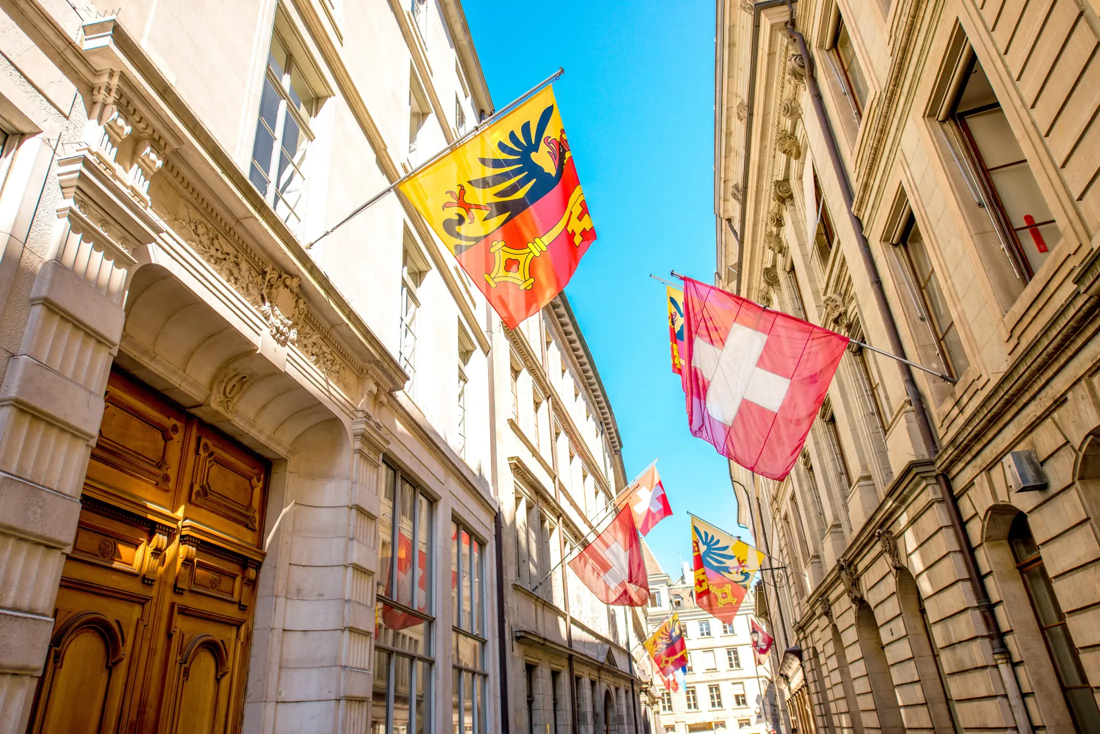 Flags of Geneva and Switzerland in the old town of Geneva